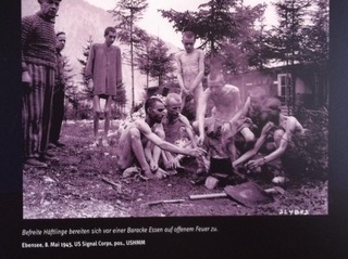 Arie Leib Žabner (second from left) with fellow survivors around a campfire following the liberation of Ebensee concentration camp, 8 May 1945.